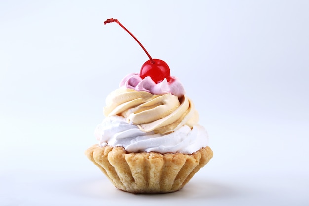 Tasty Homemade cupcake, muffin with cream and cherry. Close up view delicious sweet dessert isolated