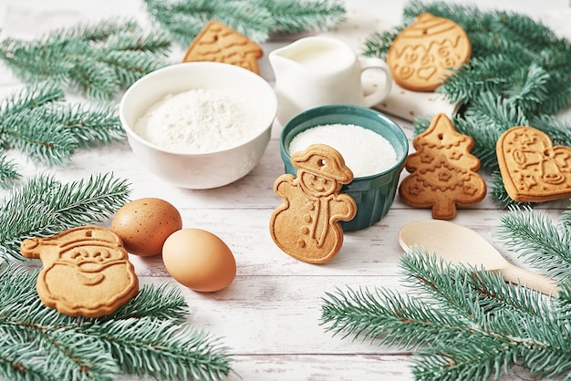 tasty homemade ginger cookies. Ingredients for cooking baking, kitchen utensils, gingerbread. Happy new year greeting card. Xmas table. Fir tree, pine.