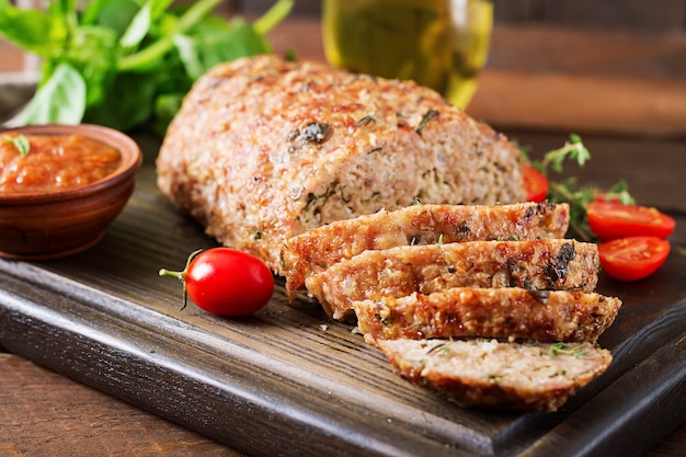 Tasty homemade ground  baked turkey meatloaf on wooden table.