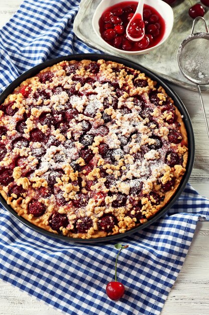 Tasty homemade pie with cherries on table close up