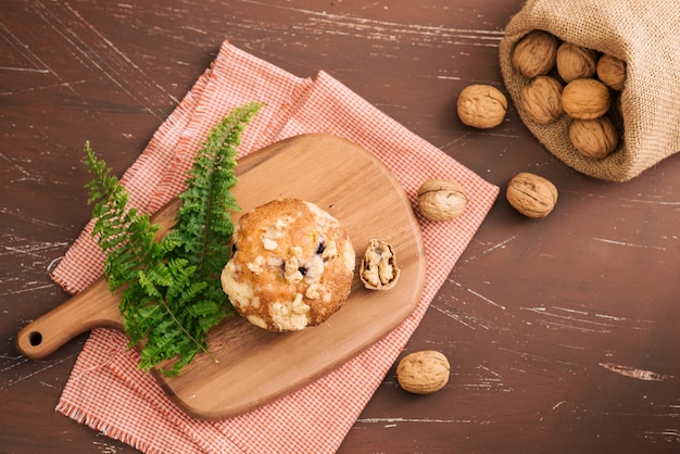 Tasty homemade walnut muffins on table. Sweet pastries