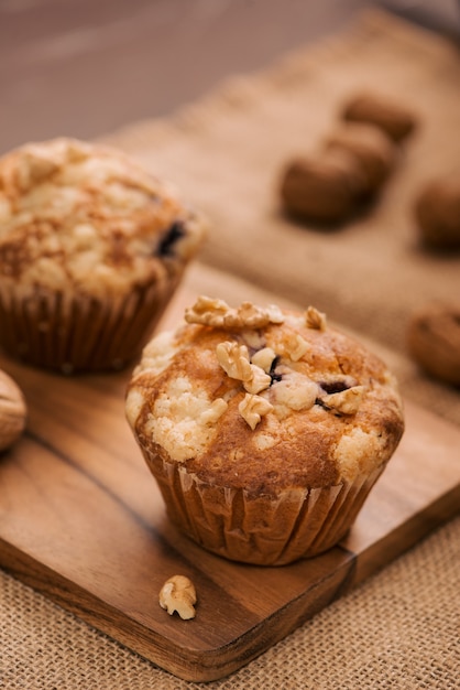 Tasty homemade walnut muffins on table. Sweet pastries