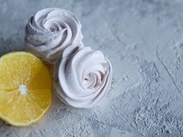 Tasty homemade zephyr with lemon flavour grey background