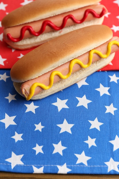 Tasty hot dogs on napkin with stars