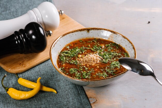 Tasty hot soup dish on the wooden background