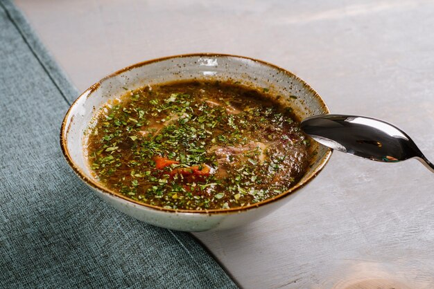 Tasty hot soup dish on the wooden background