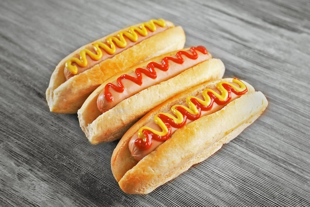 Tasty hotdogs on wooden background