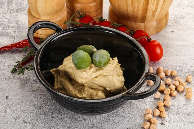 Tasty hummus with green olives