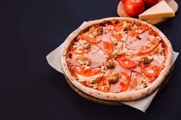 Tasty Italian pizza on black concrete background