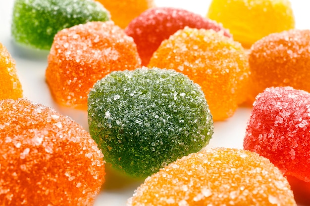 Tasty jelly candies on white background closeup