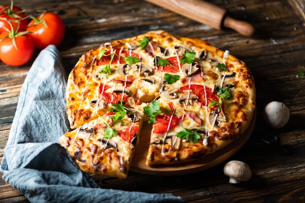 Tasty juicy pizza on wooden background lots of meat and cheese Mushroom pizza Pepperoni pizza Mozzarella and tomato Italian dish Italian food Comfort food Local food