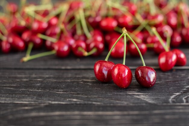 Tasty juicy sweet cherry on a wooden background. 