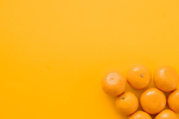 Tasty juicy tangerines on yellow background