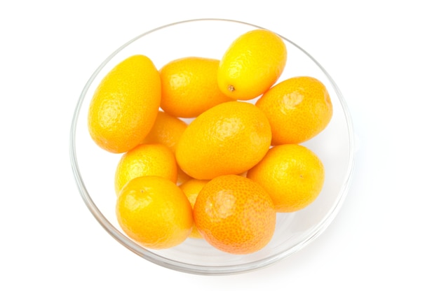 Tasty kumquat in the bowl isolated on white