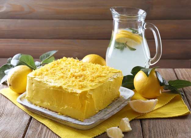 Tasty lemon cake on wooden table