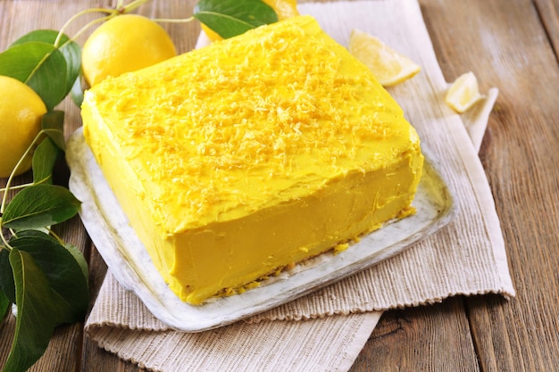 Tasty lemon cake on wooden table