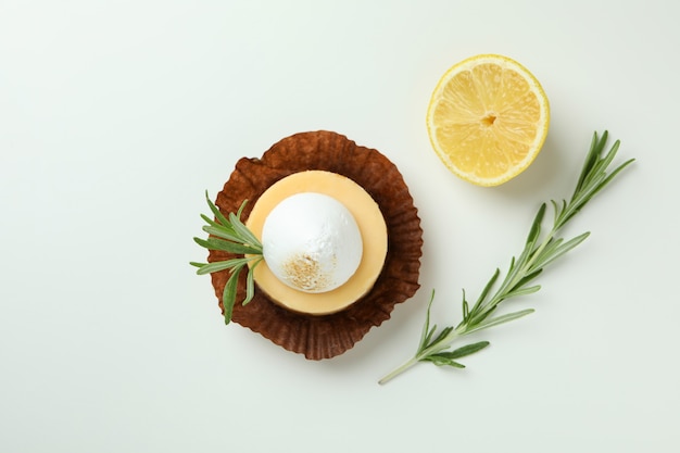 Tasty lemon cupcake on white background, top view