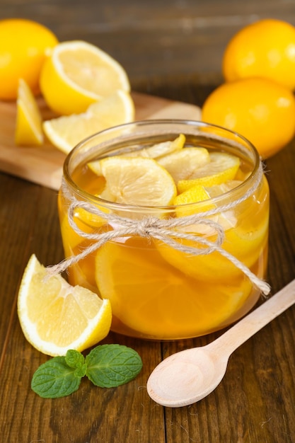 Tasty lemon jam on table closeup