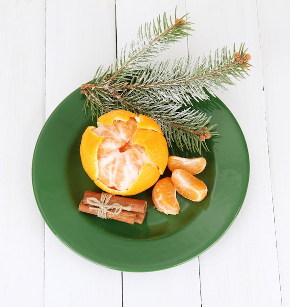 Tasty mandarines color plate on light background