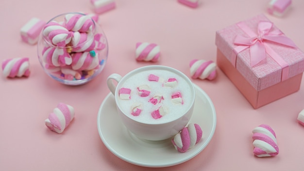 Tasty marshmallows on a pink background