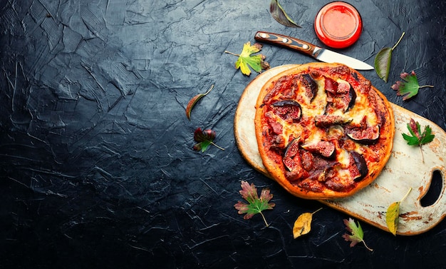 Tasty meat pizza with fig,space for text