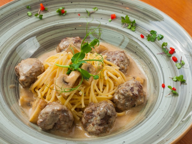 Tasty meatballs with spaghetti in creamy truffle sauce