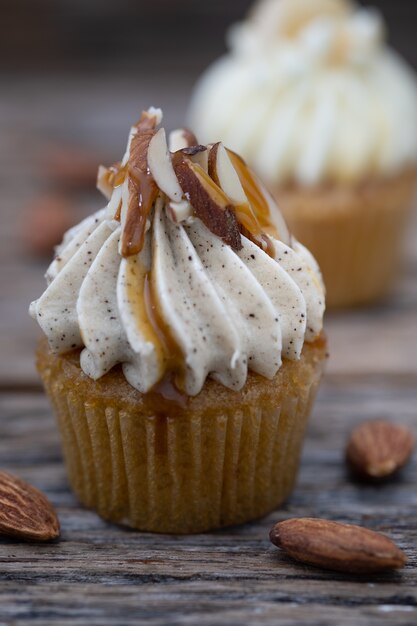 Tasty mini cupcakes on a vintage background, sweet dessert 