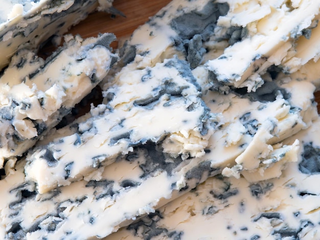 Tasty moldy cheese texture background Blue mold cheese close up