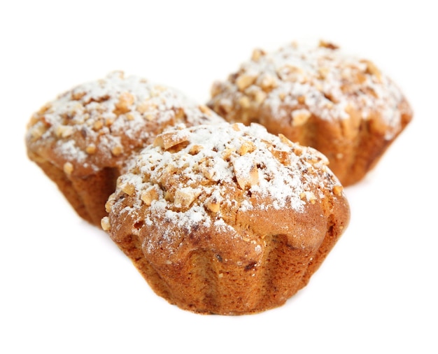 Tasty muffin cakes with powdered sugar isolated on white