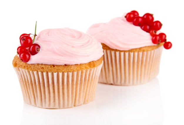 Tasty muffins with berries on white