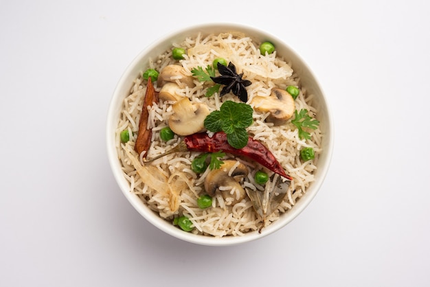Tasty Mushroom or Mashroom Rice or Pulav or Pilaf or Pulao or Biryani served in a bowl or plate, selective focus