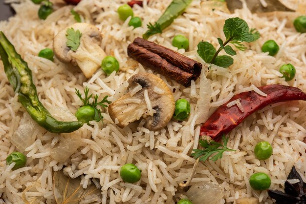 Tasty Mushroom or Mashroom Rice or Pulav or Pilaf or Pulao or Biryani served in a bowl or plate, selective focus