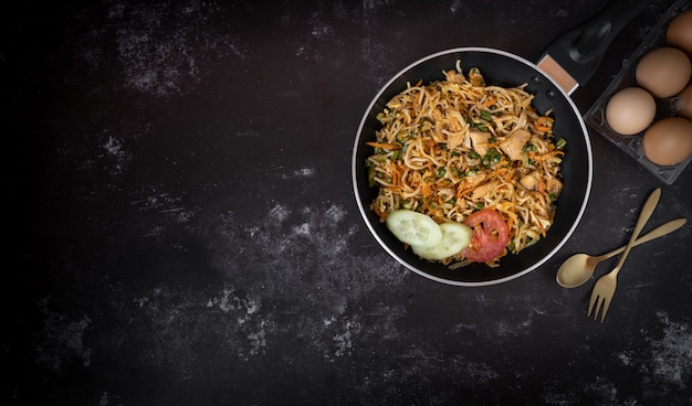 Tasty noodle in a dark background with a space for text or messages