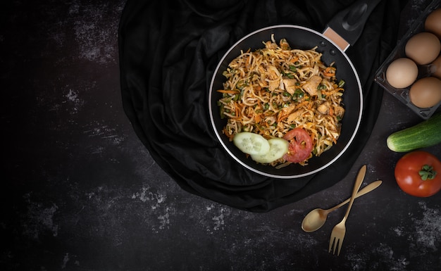 Tasty noodle in a dark background with a space for text or messages 