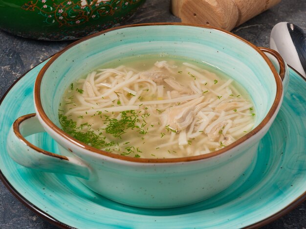 Tasty noodle soup with chicken in a restaurant