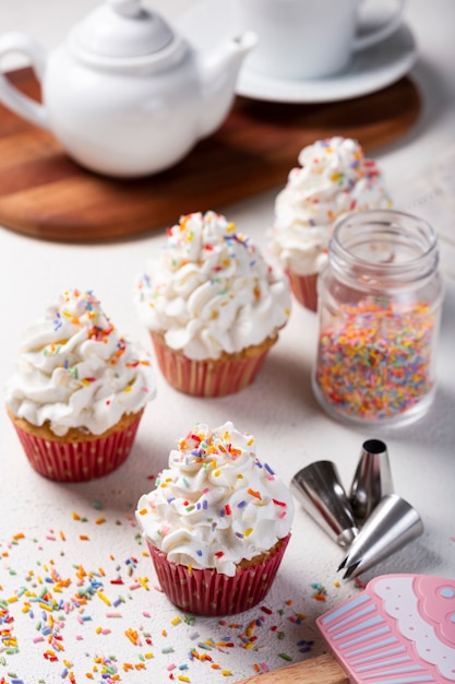 Tasty party cupcakes on the table Cupcakes with whipped cream