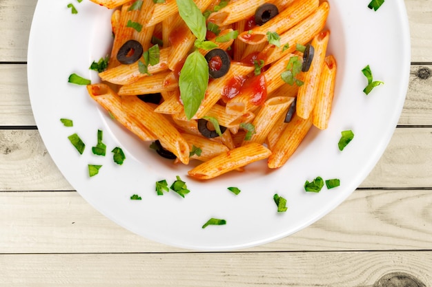 Tasty  pasta and parsley on  table.