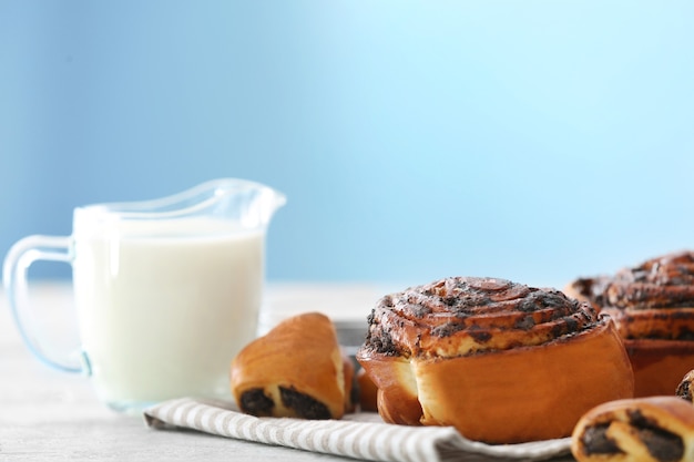 Tasty pastries with poppy seeds on table