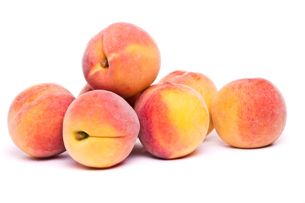 Tasty peaches on white