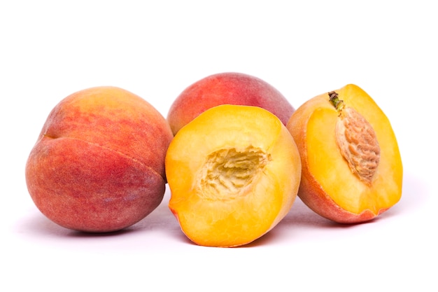 Tasty peaches on white