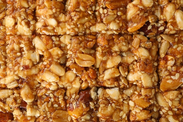 Photo tasty peanut brittle on whole background, close up