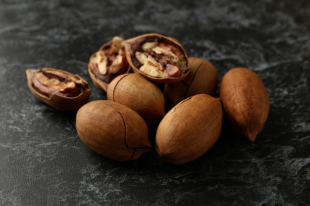 Tasty pecan nuts on black smokey