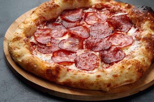 Tasty pepperoni pizza on black concrete background Top view of hot pepperoni pizza With copy space for text