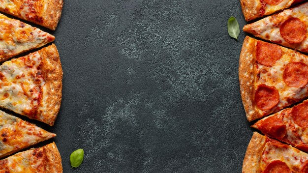 Photo tasty pepperoni pizza and cooking ingredients tomatoes basil on black concrete background