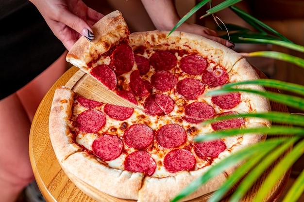 Tasty pepperoni pizza and cooking ingredients tomatoes basil