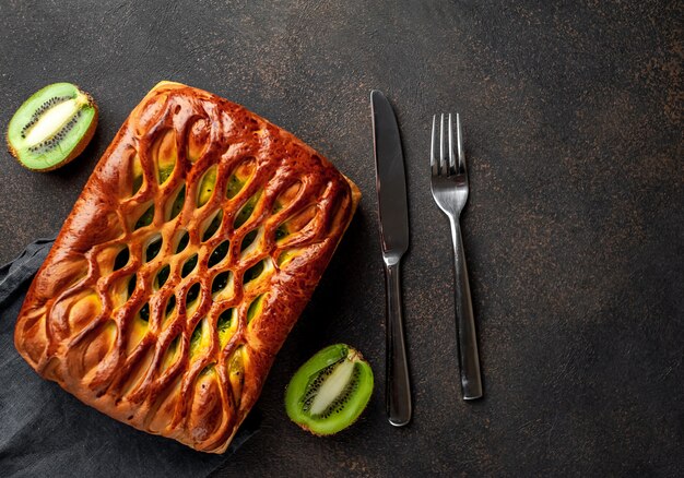 tasty pie with kiwi filling ready to eat on a stone background  