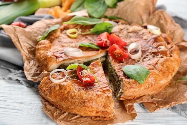 Tasty pie with spinach on table