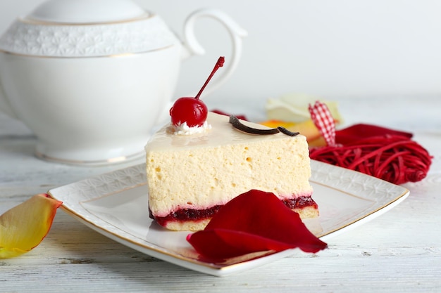 Tasty piece of cheesecake on plate on table close up