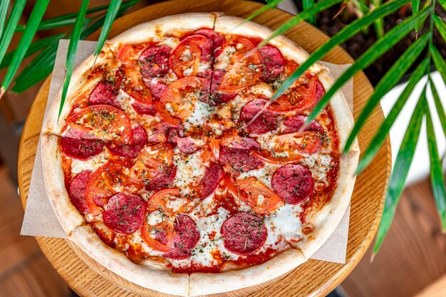 Tasty pizza and cooking ingredients tomatoes basil