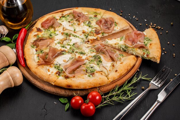 Tasty pizza with philadelphia cheese and ham on wooden background